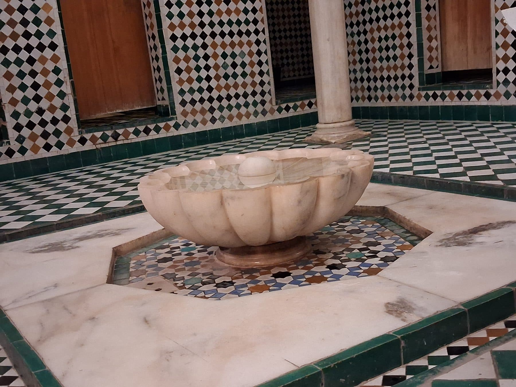 Vasque de marbre au centre d'un sol en zellige, médersa Ben Youssef